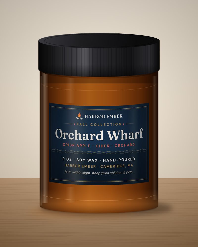Harbor Ember Orchard Wharf 9 oz soy candle in an amber jar with a black lid